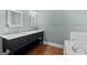 Bathroom with dual sinks, black vanity and white marble countertops at 441 Crumbley Rd, Mcdonough, GA 30252