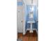 Bathroom with blue walls, white pedestal sink, mirror, and trim with dark wood-look flooring at 441 Crumbley Rd, Mcdonough, GA 30252
