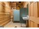 Rustic bathroom includes toilet stalls, sink, mirror and wooden walls at 441 Crumbley Rd, Mcdonough, GA 30252