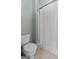 Bathroom with a toilet and a shower with white shower curtain at 441 Crumbley Rd, Mcdonough, GA 30252