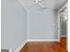 Bedroom featuring hardwood floors, light blue walls, white trim and baseboards and a ceiling fan at 441 Crumbley Rd, Mcdonough, GA 30252