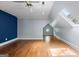 Spacious bedroom with dark blue accent wall, light blue wall, skylight, and octagon window at 441 Crumbley Rd, Mcdonough, GA 30252