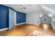 Large bedroom with dark blue accent wall, light blue wall, and a octagon window at 441 Crumbley Rd, Mcdonough, GA 30252