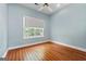 Bright bedroom features hardwood floors, a ceiling fan, and a window with lots of natural light at 441 Crumbley Rd, Mcdonough, GA 30252