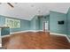 Bonus room boasts high ceilings, hardwood floors, a window and a mounted television at 441 Crumbley Rd, Mcdonough, GA 30252