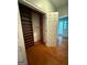 A bedroom closet with built-in shelves and hardwood flooring at 441 Crumbley Rd, Mcdonough, GA 30252