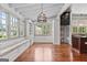 Sun-filled dining area with a built-in bench seat, hardwood floors, and access to the kitchen at 441 Crumbley Rd, Mcdonough, GA 30252