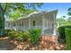 Inviting exterior with covered porch, brick steps, and lush landscaping at 441 Crumbley Rd, Mcdonough, GA 30252