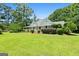 Landscaped front yard leads to a covered front porch offering a serene and inviting curb appeal at 441 Crumbley Rd, Mcdonough, GA 30252
