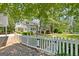 Elegant two-story home with a white picket fence and lush landscaping, exuding curb appeal at 441 Crumbley Rd, Mcdonough, GA 30252