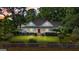 Inviting home with a red door, white picket fence, and beautifully manicured lawn at 441 Crumbley Rd, Mcdonough, GA 30252