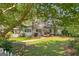 Charming white home with a welcoming front porch and lush green lawn surrounded by mature trees at 441 Crumbley Rd, Mcdonough, GA 30252