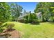 Lush front yard with manicured shrubs and a well-kept lawn, enhancing curb appeal at 441 Crumbley Rd, Mcdonough, GA 30252