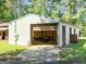 Garage with roll up door and wooden doors, surrounded by a lush green lawn at 441 Crumbley Rd, Mcdonough, GA 30252