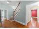 Entryway hallway with hardwood floors, a staircase, and access to multiple rooms at 441 Crumbley Rd, Mcdonough, GA 30252