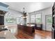 Open-concept kitchen featuring an island with seating, stainless steel appliances, and a dining area with natural light at 441 Crumbley Rd, Mcdonough, GA 30252