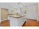 Open kitchen with wooden island, white cabinets, and stainless steel appliances at 441 Crumbley Rd, Mcdonough, GA 30252