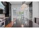Kitchen with a center island, dark wood cabinets, and a view into the light-filled dining area at 441 Crumbley Rd, Mcdonough, GA 30252