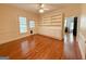 A living room with hardwood flooring, cream walls, and white trim features built in shelving at 441 Crumbley Rd, Mcdonough, GA 30252