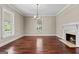 Charming living room with fireplace, chandelier and natural lighting at 441 Crumbley Rd, Mcdonough, GA 30252