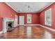 Cozy living room with a brick fireplace, built-in shelves, hardwood floors, and ample lighting at 441 Crumbley Rd, Mcdonough, GA 30252