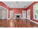 Comfortable living room featuring a fireplace, hardwood floors, and bright natural light at 441 Crumbley Rd, Mcdonough, GA 30252