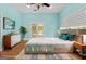Cozy bedroom featuring hardwood floors, a comfortable bed, and stylish decor at 441 Crumbley Rd, Mcdonough, GA 30252