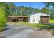 Driveway view of an outbuilding with a brown wooden barn attached at 441 Crumbley Rd, Mcdonough, GA 30252