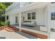 A charming front porch featuring a hanging swing-bed, perfect for relaxing outdoors at 441 Crumbley Rd, Mcdonough, GA 30252