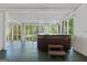 Enclosed porch featuring a hot tub with green floors and screened windows at 441 Crumbley Rd, Mcdonough, GA 30252