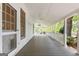 Covered porch with white railings and a ceiling fan, providing a relaxing outdoor space at 441 Crumbley Rd, Mcdonough, GA 30252