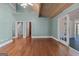 Open room with hardwood floors, french doors, and a staircase to upper level at 441 Crumbley Rd, Mcdonough, GA 30252