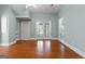 Large room with hardwood floors, ceiling fan, and a back door at 441 Crumbley Rd, Mcdonough, GA 30252