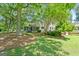 Landscaped yard boasts a charming screened porch, patio, and vibrant greenery, perfect for outdoor living at 441 Crumbley Rd, Mcdonough, GA 30252