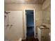 Bathroom featuring tiled shower-tub, single sink vanity and window at 6236 Shallow Creek Ln, Douglasville, GA 30135