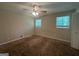 Bedroom with neutral walls, carpet, ceiling fan and two windows providing lots of natural light at 6236 Shallow Creek Ln, Douglasville, GA 30135
