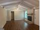 Living room features a cozy brick fireplace, wood floors, a vaulted ceiling and ample natural light at 6236 Shallow Creek Ln, Douglasville, GA 30135