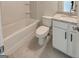 A bathroom with a white toilet, shower/bath, and vanity with granite countertop at 3292 Mill Forest Sw Dr, Conyers, GA 30094