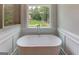 Bathroom featuring a stand alone tub, window with natural light, and walk-in shower at 3292 Mill Forest Sw Dr, Conyers, GA 30094