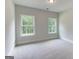 Light-filled bedroom with plush carpet and dual windows, offering serene views at 3292 Mill Forest Sw Dr, Conyers, GA 30094