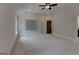 Bedroom with ceiling fan and staircase, showcasing an open layout and bright atmosphere at 3292 Mill Forest Sw Dr, Conyers, GA 30094