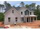Beautiful new construction home with light brick facade and welcoming front porch at 3292 Mill Forest Sw Dr, Conyers, GA 30094