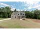 Newly built home featuring a manicured lawn and a mix of brick and siding exterior at 3292 Mill Forest Sw Dr, Conyers, GA 30094