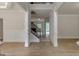 Elegant foyer showcasing hardwood floors, decorative columns, and a staircase leading upstairs at 3292 Mill Forest Sw Dr, Conyers, GA 30094