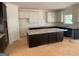 Bright kitchen boasts white and dark cabinets, granite countertops, and a central island at 3292 Mill Forest Sw Dr, Conyers, GA 30094