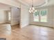 Open living space with decorative columns, natural light, and hardwood floors, perfect for entertaining at 3292 Mill Forest Sw Dr, Conyers, GA 30094