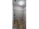 Tiled laundry room with ample shelving and washer/dryer hookups for convenience at 1230 Chris Lake Dr, Lawrenceville, GA 30046