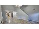 Open-concept living space with tile floors, fireplace, staircase, and arched entry to the kitchen at 1230 Chris Lake Dr, Lawrenceville, GA 30046