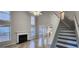 Bright living area features tall windows, a fireplace, staircase, neutral paint, and tile flooring at 1230 Chris Lake Dr, Lawrenceville, GA 30046