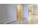 Open-concept living space features neutral paint, tile floors, and arched doorways that add architectural interest at 1230 Chris Lake Dr, Lawrenceville, GA 30046